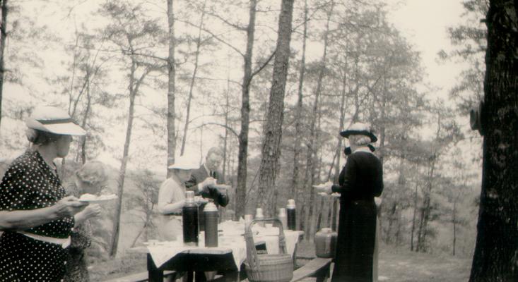 Women and one man at a picnic, Mary Shelby Wilson in front