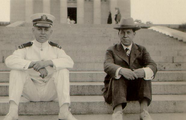 Naval officer and a man on steps of building