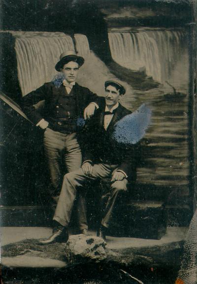 Two men with painting of Niagara Falls in background, c.1856-1900; in paper mat (2 copies). Listed and described in 19th Century Photographs, a catalogue from UK Special Collections