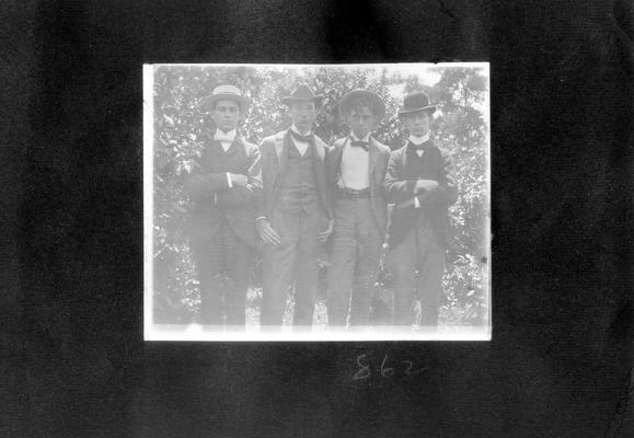 Four young men standing outdoors