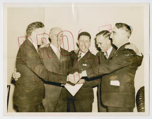 Vinson with men who helped override the presidential veto of the Baby Bond Bonus Payment Plan. Left to right: Representative John W. McCormack, Massachusetts; Ray Murphy, National Commander of the Veterans of Foreign Wars; M.A. Harlan, Disabled American Veterans; Representative Vinson, Kentucky; and unidentified man