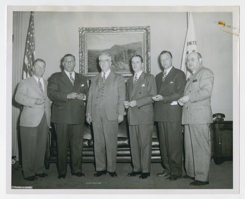 Secretary of Treasury Vinson with second set of recipients of the Treasury's Silver Medal for Distinguished Service in War Finance, 1941-45. Left to right: George M. Dorsey, RKO Pathe News; Anthony Moto, Twentieth Century-Fox Movie News; Secretary Vinson; Robert H Denton, Paramount News; James E. Lyons, Universal Newsreel; and J.C. Brown, MGM News of the Day