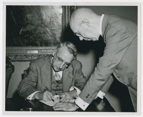 Secretary Vinson signs document