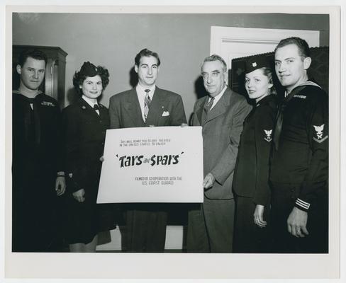 Secretary Vinson with military personnel at premiere of Tars and Spars at the Metropolitan Theater. Pose A