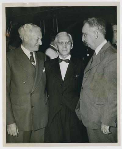 Secretary Vinson, right, with two unidentified men
