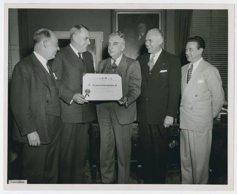 Secretary Vinson presents citation to Frank J. Raltje, President of the American Bankers Association, in connection with War Bond Program. Left to right:  Francis M. Knight, chairman, ABA Committee on War Bond Drives; Frank J. Raltje, ABA president; Secretary of the Treasury Fred Vinson; Fred M. Naba, vice chairman, ABA Committee on War Bond Drives; Ted R. Gamble, national director, War Finance Division