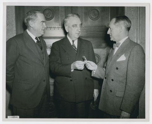 Secretary Vinson presents Treasury Award Silver Medals for Distinguished Service in War Finance, in the Federal Reserve building, Washington, D.C. Left, Allan Sproul, Chairman of the Presidents of the Federal Reserve Banks; right, Marriner S. Eccles, Chairman of the Federal Reserve Board
