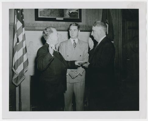 Chief Justice Vinson, right, swears in Judge John W. Murphy with Justice Clark, center