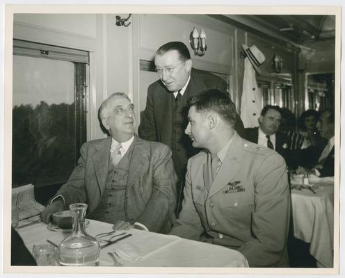 Chief Justice Vinson, left, with Basil O'Conner, center, and General Alpha Fowler, right, seated at railroad car dining table
