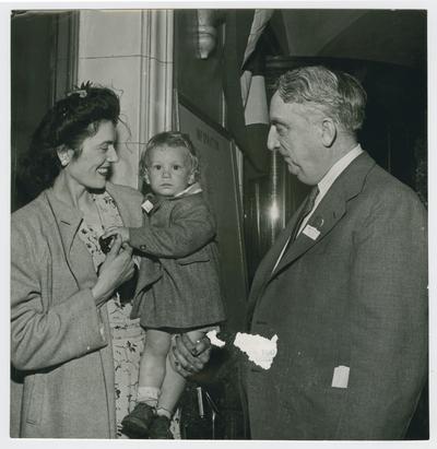 Secretary Vinson greets a mother and her baby at Savannah Conference