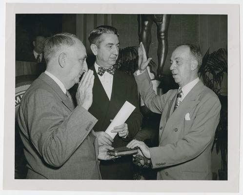 Chief Justice Vinson, left, swears in Philip B. Perlman as Solicitor General with Justice Clark, center, attending