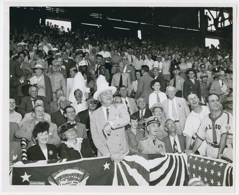 President Truman, center, and Secretary Vinson, to right and behind Truman, at opening baseball game at Griffith Stadium