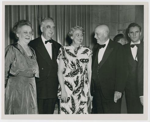 Eleanor Roosevelt, left, Chief Justice Vinson, second from left, Sam Rayburn, fourth from left, and unidentified man and woman at reception for Mrs. Roosevelt given by McCall's Magazine