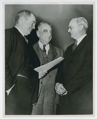 Chief Justice Vinson, center, with two unidentified men