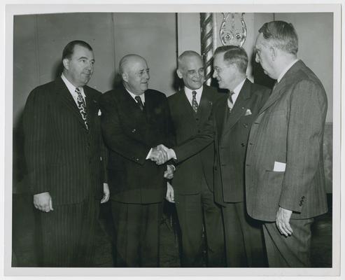 Chairman Ramspeck's swearing-in ceremony at the Civil Service Commission. Left to right: Randolph Jennings, Speaker Rayburn, Justice Burton, Robert Ramspeck, and Chief Justice Vinson