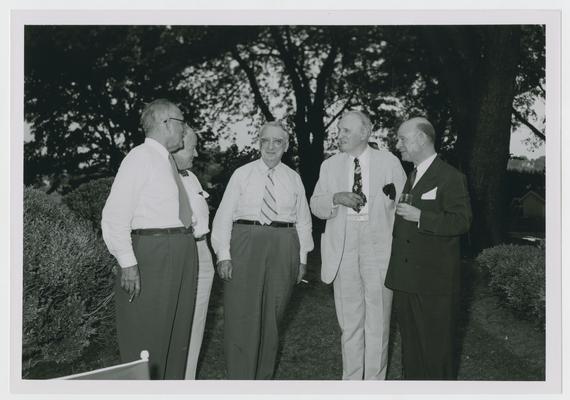 Chief Justice Vinson, center, with five unidentified men in outdoor setting