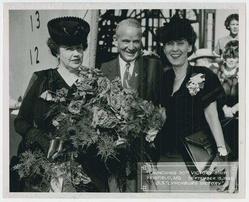 Page 7 of 38, Mrs. Vinson, roses in hand, with unidentified man and woman