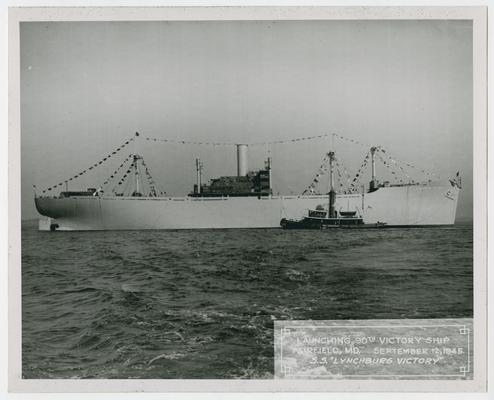 Page 21 of 38, full-length starboard side view of the S.S. Lynchburg Victory with tugboat at its side