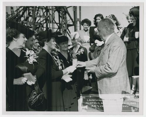 Page 23 of 38, first of two women with Mrs. Vinson as she receives plaque
