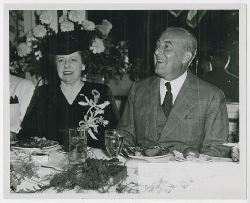 Page 26 of 38, Mrs. Vinson, with unidentified man, at dinner