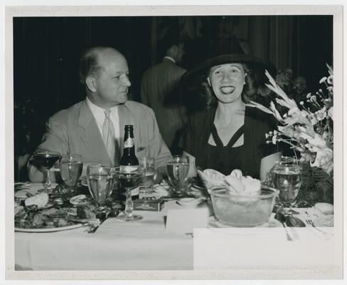 Page 35 of 38, unidentified man and woman at dinner