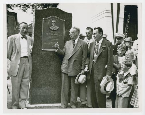Page 2 of 13, Fred M. Vinson and others next to monument commemorating his birthplace in Louisa, Kentucky