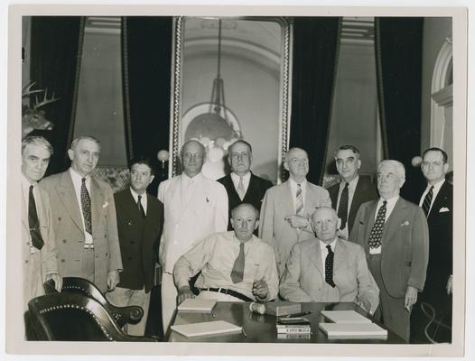 Members of the House Ways and Means Committee stand with R.L. Doughton. Left to right: first 3 men, unidentified; Thomas Cocochran; Frank Crowther; Allen Treadway; Vinson; Thomas Cullen; Jere Cooper; Pat Harrison; and Doughton