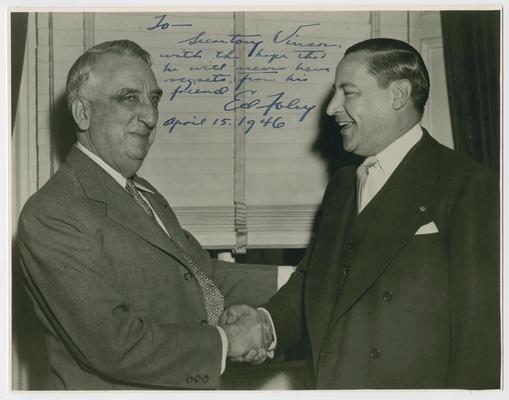Vinson shaking hands with Edward Foley. Inscribed: To Secretary Vinson, with the hope that he will never have regrets. From his friend Ed Foley