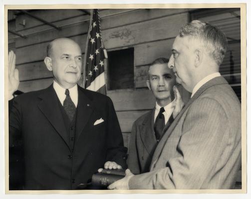 Swearing-in ceremony of Louis A. Johnson as Secretary of Defense. Left to right: Louis A. Johnson, James Forrestal, and Vinson