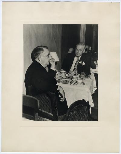 Chief Justice Vinson and unidentified man at table