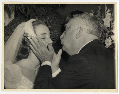 Vinson kisses Mimi Clark at her wedding