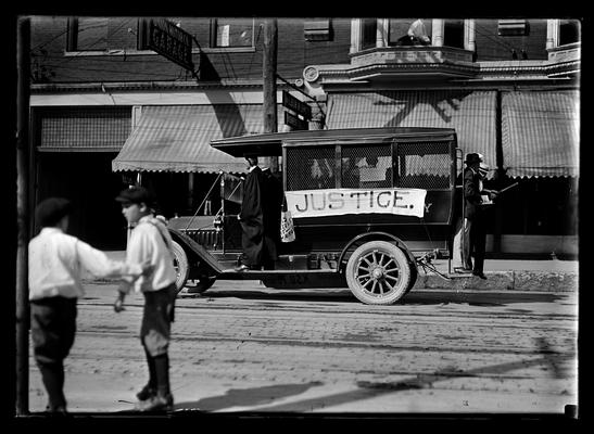 Circus parade, motor truck with Justice on side, float for Law College