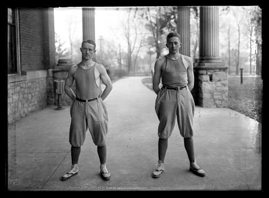 Two individual baseball players by side of Woodland auditorium, possibly George Gumbert (left) and Karl Zerfoss (right)