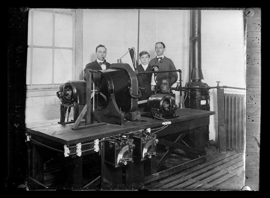 Three men with engineering equipment, copy