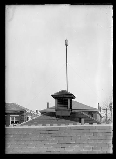 Whistle on roof of an engineering building, roofs of mining buildings in background