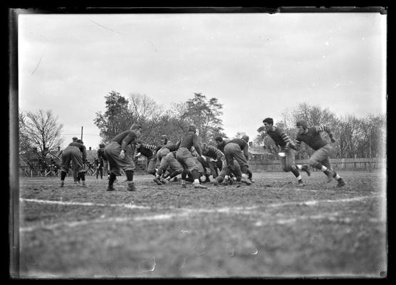 Football game at Lexington, Virginia Military Institute 3-2 against University of Kentucky, two players on right running to left