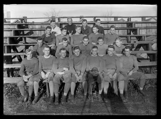 Football team on bleachers, Coach J.J. Tigert with V. on sweater, upper row, Captain Schrader with ball