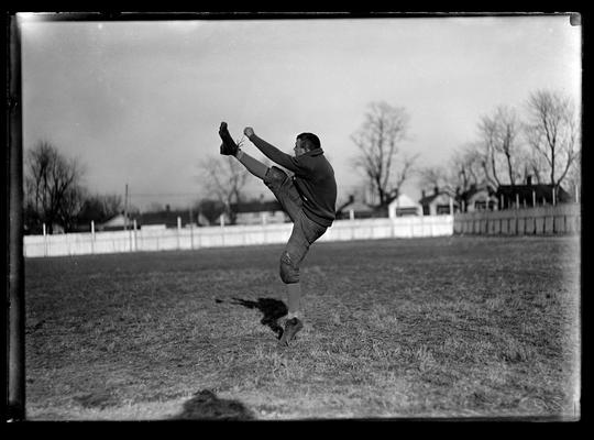 Football player kicking, William Doc Rodes