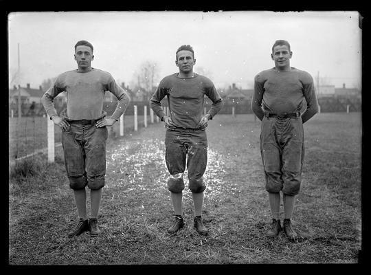 Football players in group of three: Joseph Disman, John A. Brittain, captain, guard, James Wilhelm, halfback