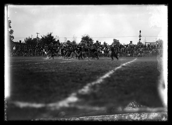 Football action, men on pole near right of picture, Brown rest. adv