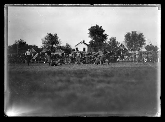 Football action, referee to left with right hand on hip