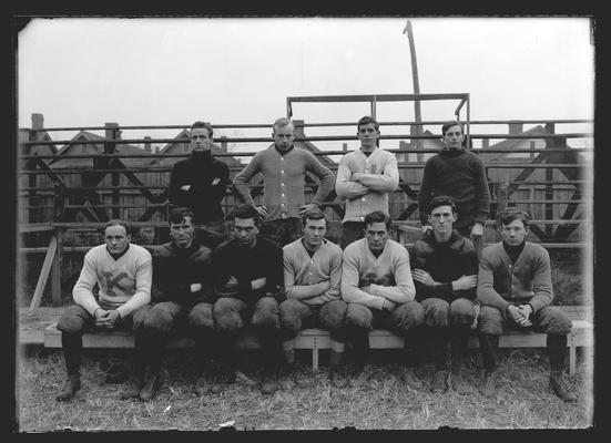 Football team, eleven players, standing, white sweater, blue K, left