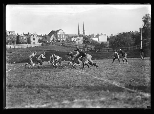 Football action, game in Cincinatti, church steeples in background, goal post to right