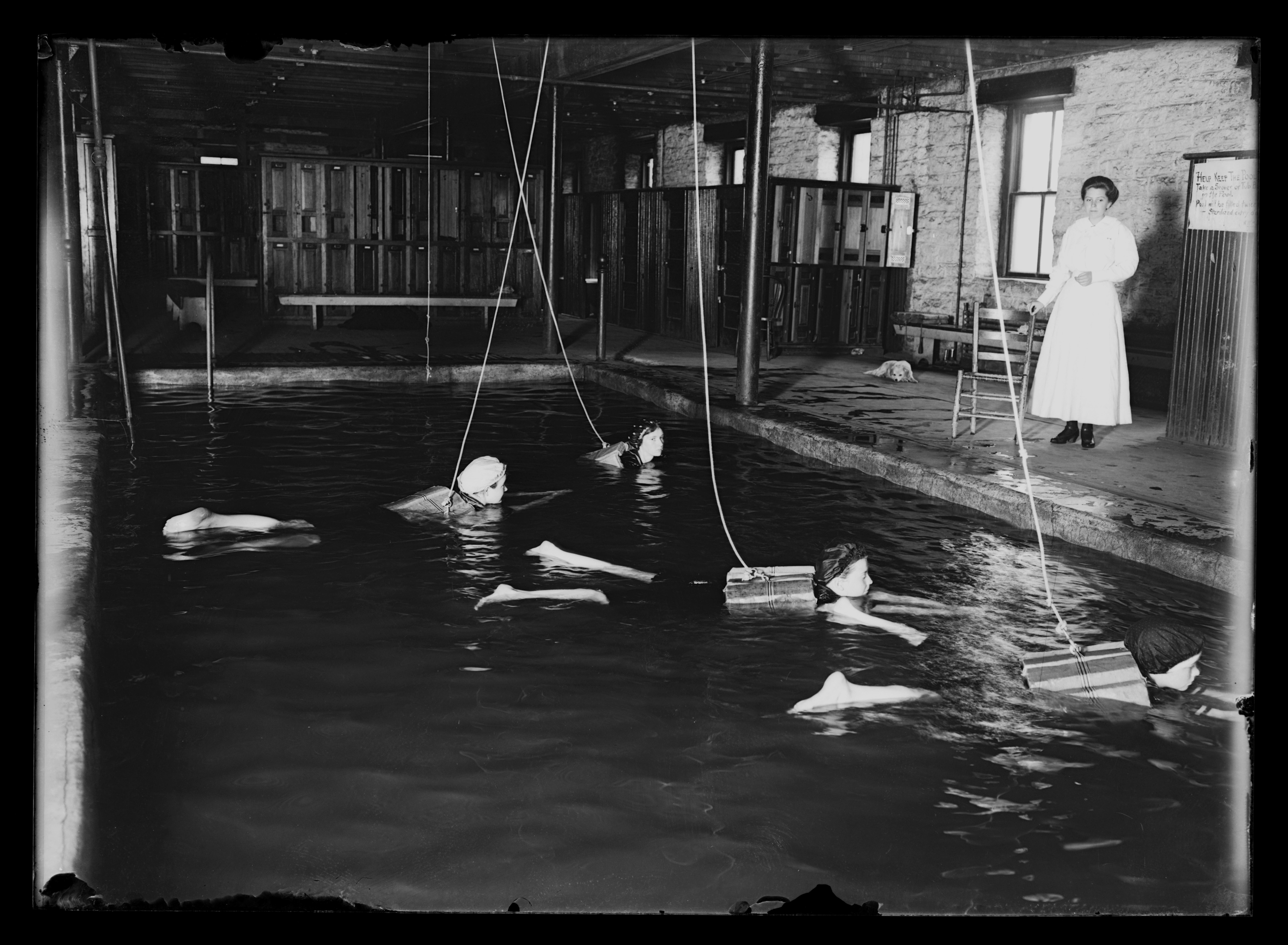 Four women swimming, pool at Lincoln School, Mrs. Stout on side, life ...
