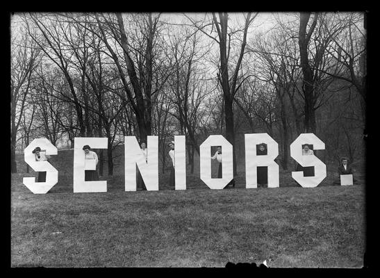 Girls behind large letters of word seniors