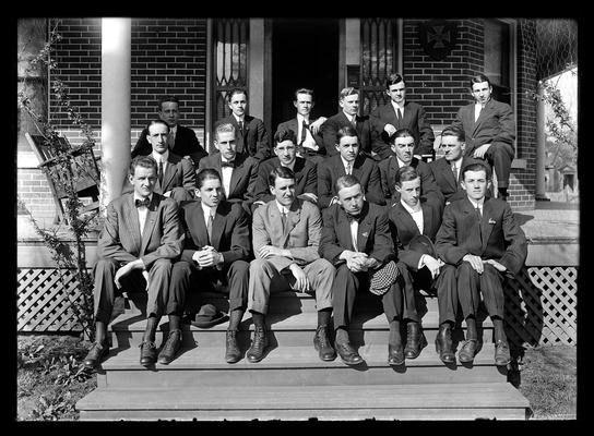 A.T.O. (Alpha Tau Omega?) fraternity, eighteen men seated, yellow brick house