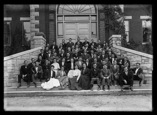 Coed group, all seated, on steps of Miller Hall