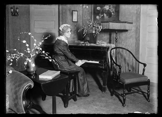 Woman seated at piano