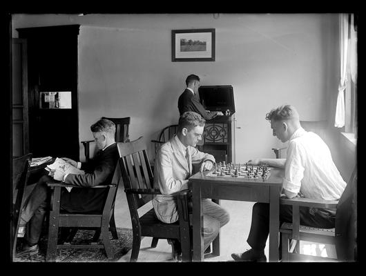 Men playing chess, probably in Young Men's Christian Association (YMCA) room in Barker Hall