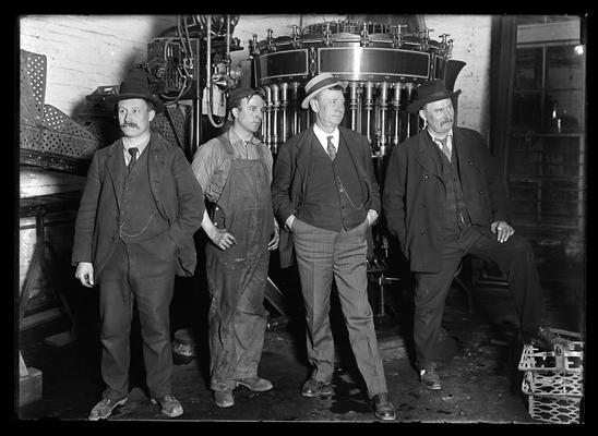 Four men in shop, John Dicker, Joe Dicker, men in shop clothes